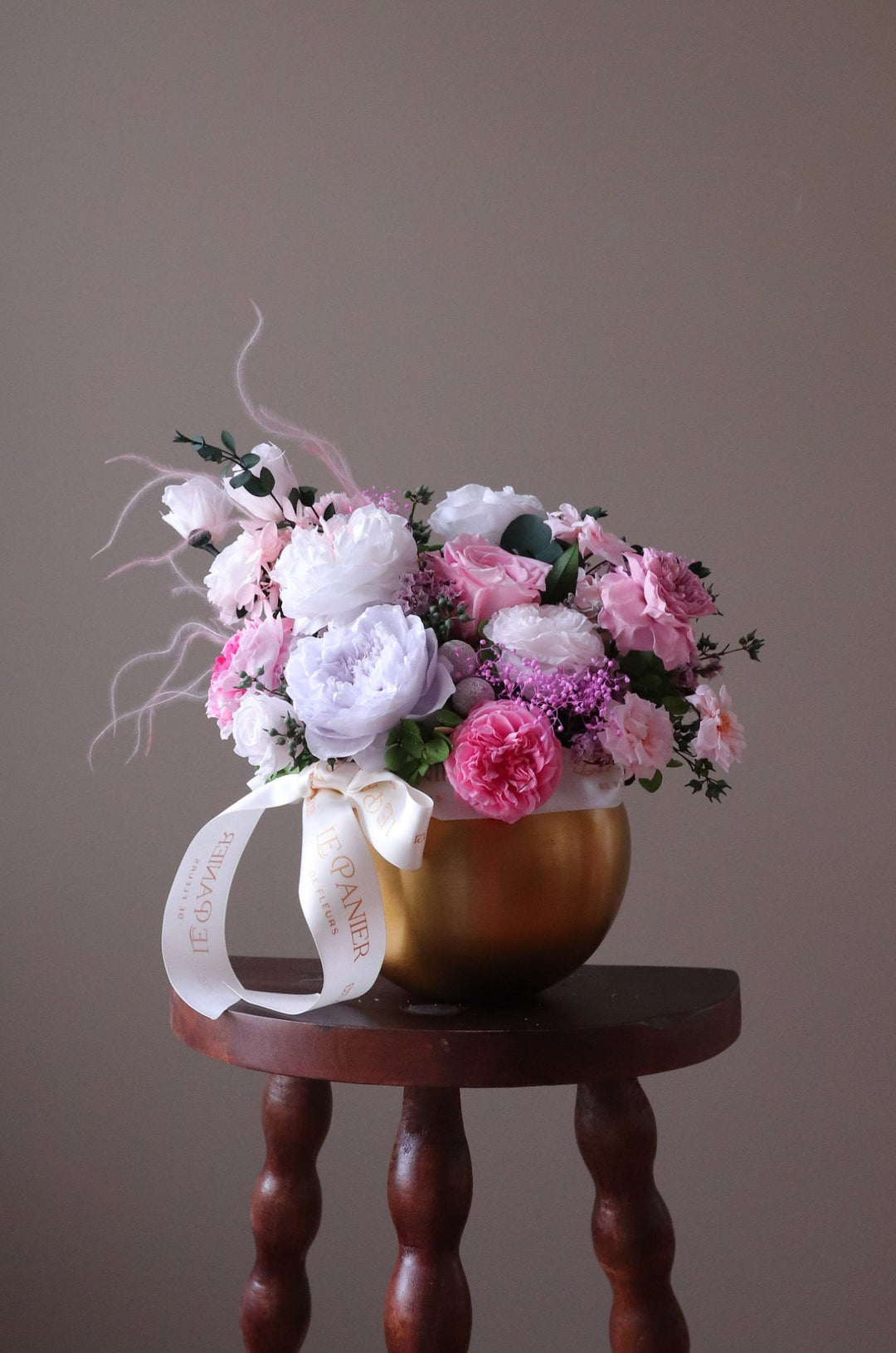 Preserved Flower arrangement in a gold round vessel featuring pink and purple garden roses