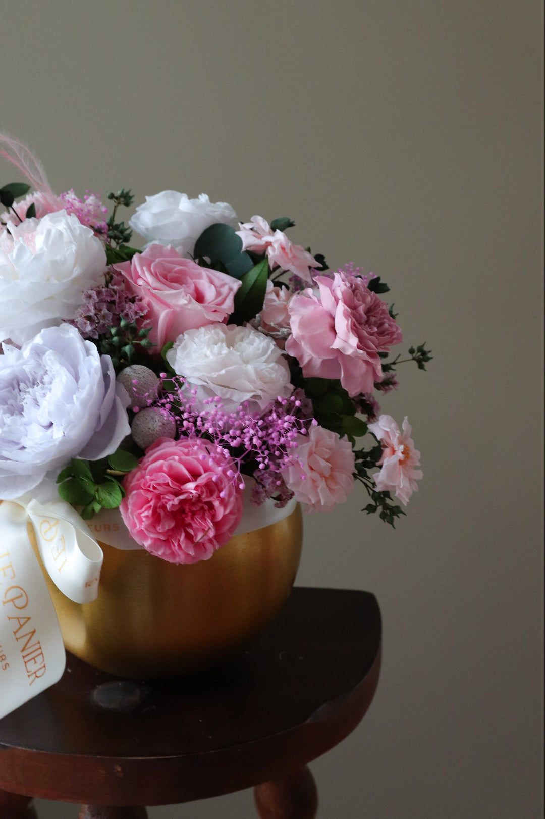 Preserved Flower arrangement in a gold round vessel featuring pink and purple garden roses
