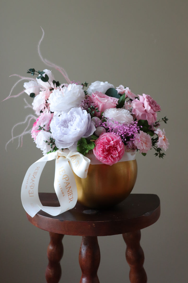 Preserved Flower arrangement in a gold round vessel featuring pink and purple garden roses