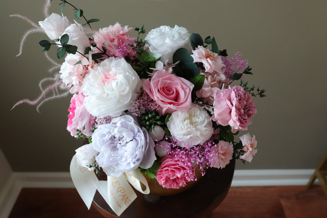 Preserved Flower arrangement in a gold round vessel featuring pink and purple garden roses
